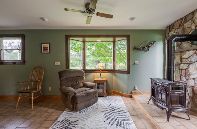 1028 Jackson Corners Rd, Red Hook, NY 12571 - living area with healthy amount of natural light, baseboards, a wood stove, crown molding, and a ceiling fan