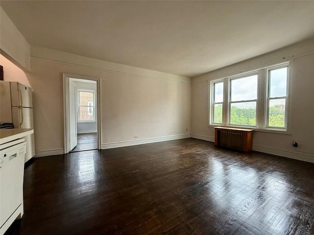 1440 Midland Unit 5F, Bronxville, NY 10708 - unfurnished living room featuring radiator heating unit, healthy amount of natural light, and dark wood finished floors