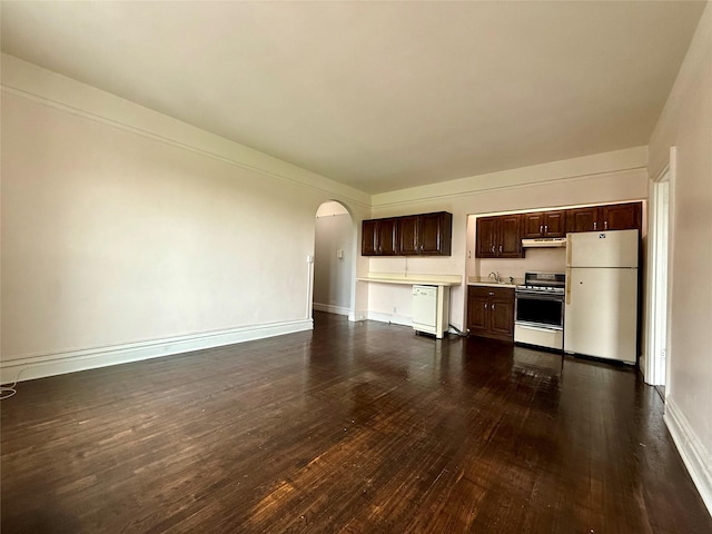 1440 Midland Unit 5F, Bronxville, NY 10708 - unfurnished living room featuring arched walkways, dark wood finished floors, a sink, and baseboards