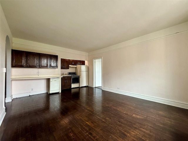 1440 Midland Unit 5F, Bronxville, NY 10708 - unfurnished living room with dark wood finished floors, arched walkways, and baseboards