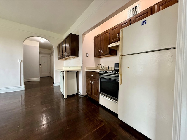 1440 Midland Unit 5F, Bronxville, NY 10708 - kitchen with freestanding refrigerator, gas range, light countertops, arched walkways, and dark wood-type flooring
