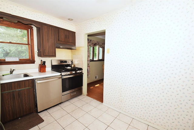 2 Walnut Dr, Syosset, NY 11791 - kitchen featuring stainless steel appliances, wallpapered walls, a sink, ventilation hood, and light countertops