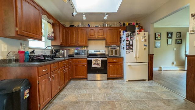 23 Kingsland Ave, Shirley, NY 11967 - kitchen with appliances with stainless steel finishes, a baseboard heating unit, a sink, dark countertops, and stone finish flooring