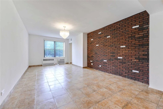 226-26 Union Tpke Unit 1E, Oakland Gardens, NY 11364 - unfurnished room featuring brick wall, radiator, an accent wall, a chandelier, and a wall mounted air conditioner