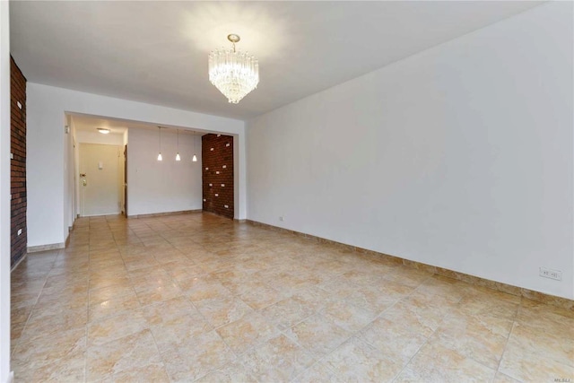 226-26 Union Tpke Unit 1E, Oakland Gardens, NY 11364 - spare room featuring a chandelier and baseboards
