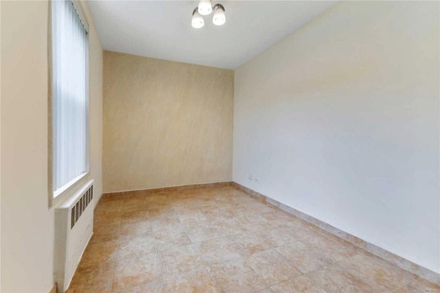 226-26 Union Tpke Unit 1E, Oakland Gardens, NY 11364 - spare room featuring radiator