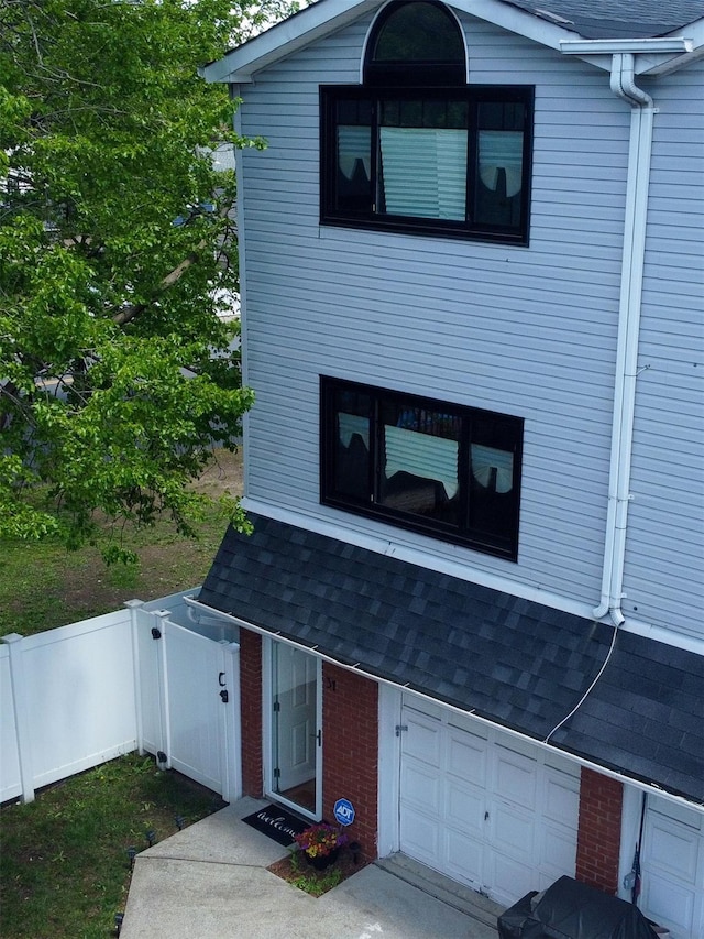 31 Charles Pl, Staten Island, NY 10303 - view of front of property featuring an attached garage, roof with shingles, and brick siding