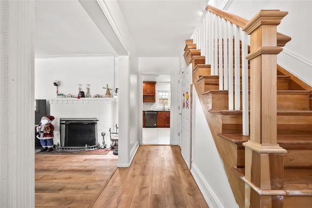34 Little Neck Rd, Little Neck, NY 11363 - stairway with a fireplace, wood finished floors, and baseboards