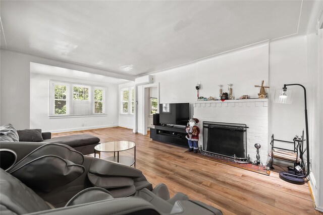 34 Little Neck Rd, Little Neck, NY 11363 - living room featuring wood finished floors, a fireplace, and an AC wall unit