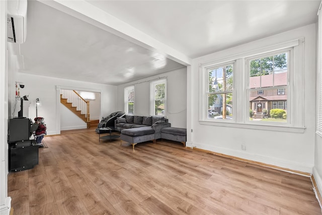 34 Little Neck Rd, Little Neck, NY 11363 - living room with stairway, light wood-style floors, baseboards, and an AC wall unit