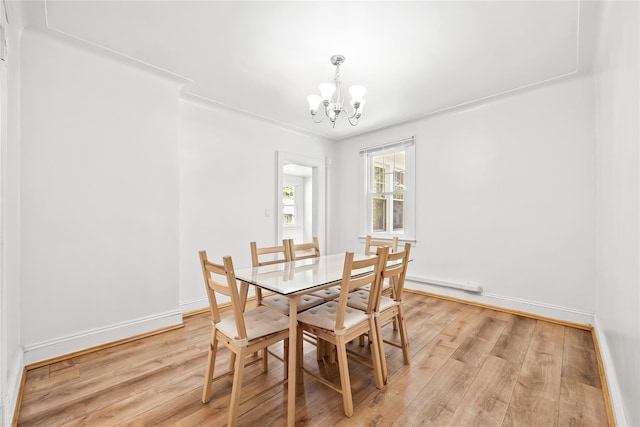 34 Little Neck Rd, Little Neck, NY 11363 - dining space with a chandelier, baseboard heating, light wood-type flooring, and baseboards