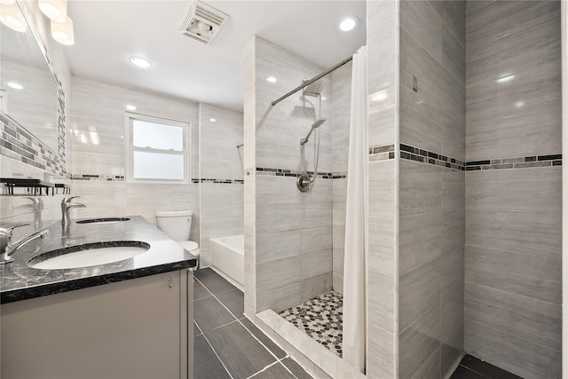 34 Little Neck Rd, Little Neck, NY 11363 - bathroom featuring a tile shower, double vanity, toilet, tile patterned floors, and recessed lighting