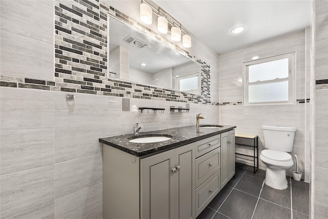 34 Little Neck Rd, Little Neck, NY 11363 - bathroom with tile walls, double vanity, tile patterned flooring, and toilet