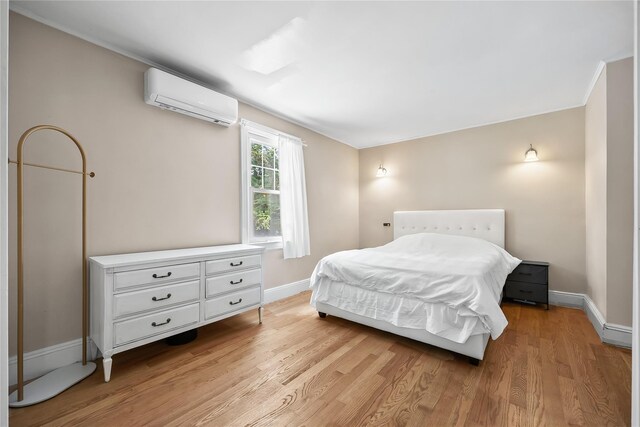 34 Little Neck Rd, Little Neck, NY 11363 - bedroom featuring a wall mounted AC, light wood-style floors, and baseboards