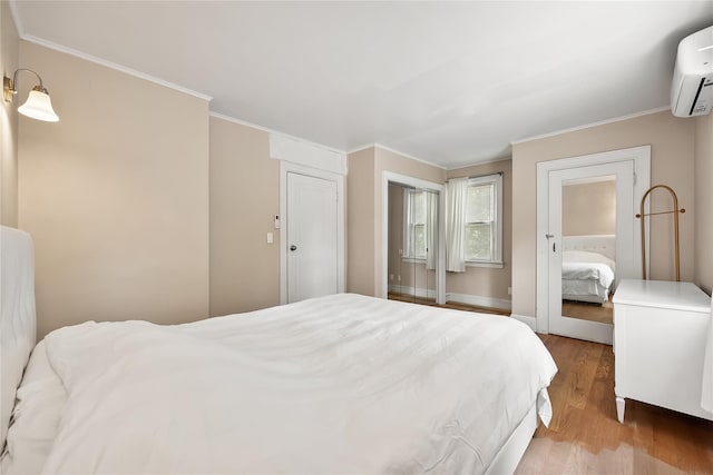 34 Little Neck Rd, Little Neck, NY 11363 - bedroom with an AC wall unit, wood finished floors, crown molding, and baseboards