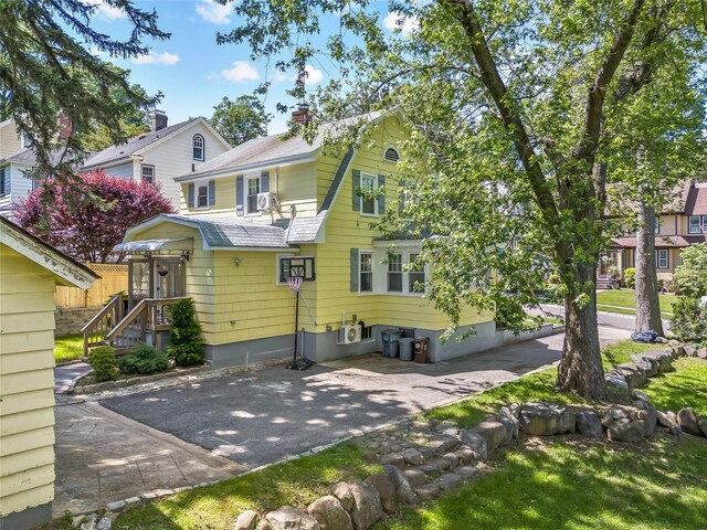 34 Little Neck Rd, Little Neck, NY 11363 - rear view of house featuring a shingled roof, a chimney, and driveway