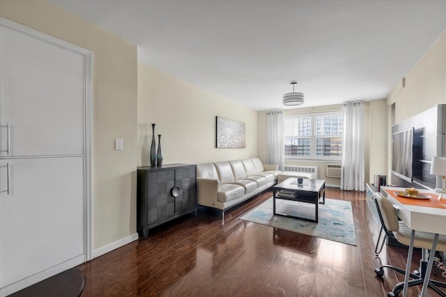 61-15 97th St Unit 6A, Rego Park, NY 11374 - living area with dark wood-type flooring, radiator, baseboards, and an AC wall unit