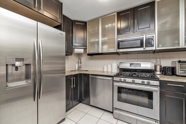 61-15 97th St Unit 6A, Rego Park, NY 11374 - kitchen with appliances with stainless steel finishes, a sink, backsplash, and light stone countertops