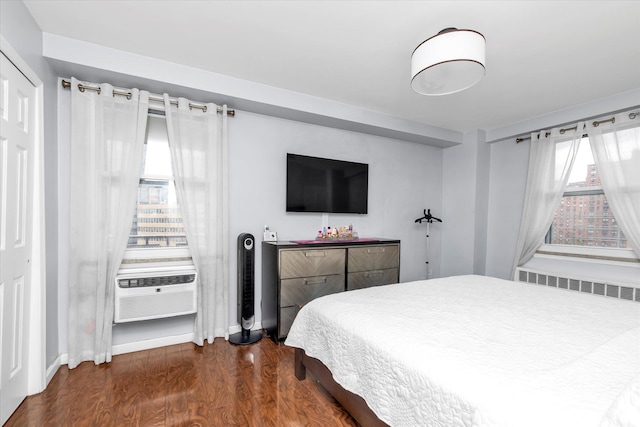 61-15 97th St Unit 6A, Rego Park, NY 11374 - bedroom featuring radiator heating unit, wood finished floors, baseboards, and cooling unit
