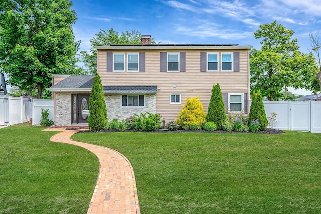 49 Rainbow Ln, Levittown, NY 11756 - view of front of home featuring a chimney, stone siding, and a gate