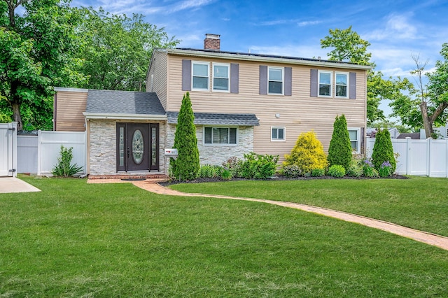 49 Rainbow Ln, Levittown, NY 11756 - view of front facade featuring stone siding and a chimney