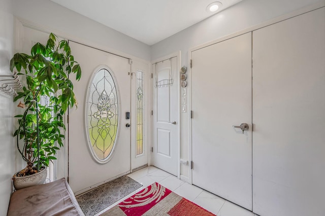 49 Rainbow Ln, Levittown, NY 11756 - foyer featuring light tile patterned flooring