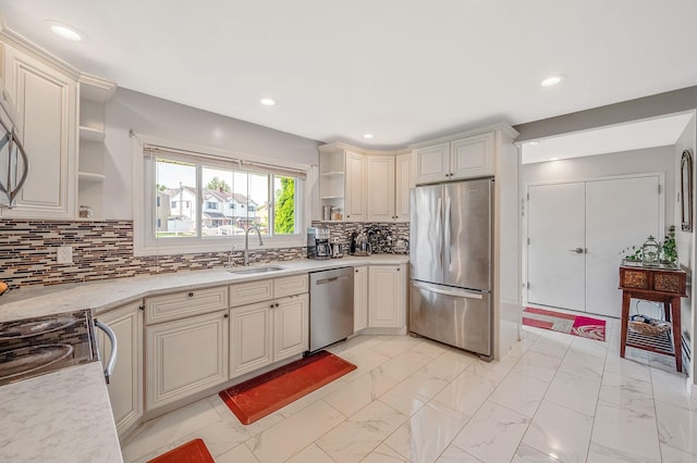 49 Rainbow Ln, Levittown, NY 11756 - kitchen with stainless steel appliances, open shelves, cream cabinets, a sink, and light marble finish flooring