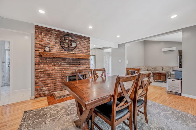 49 Rainbow Ln, Levittown, NY 11756 - dining room with an AC wall unit, recessed lighting, baseboards, and light wood finished floors