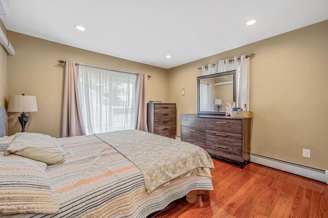 49 Rainbow Ln, Levittown, NY 11756 - bedroom with a baseboard radiator, light wood-style flooring, and recessed lighting