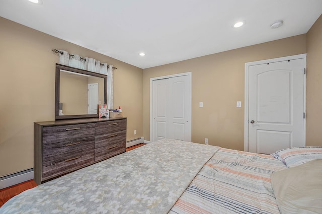 49 Rainbow Ln, Levittown, NY 11756 - bedroom featuring wood finished floors, recessed lighting, baseboard heating, baseboards, and a closet
