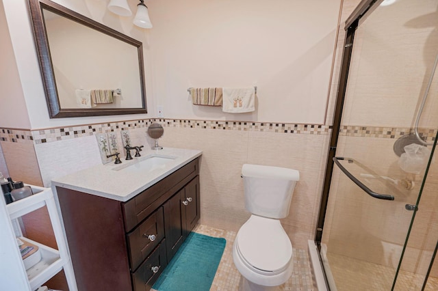 49 Rainbow Ln, Levittown, NY 11756 - bathroom with tile walls, a stall shower, toilet, vanity, and a wainscoted wall