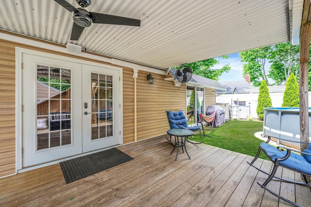49 Rainbow Ln, Levittown, NY 11756 - wooden deck with french doors, ceiling fan, and a yard