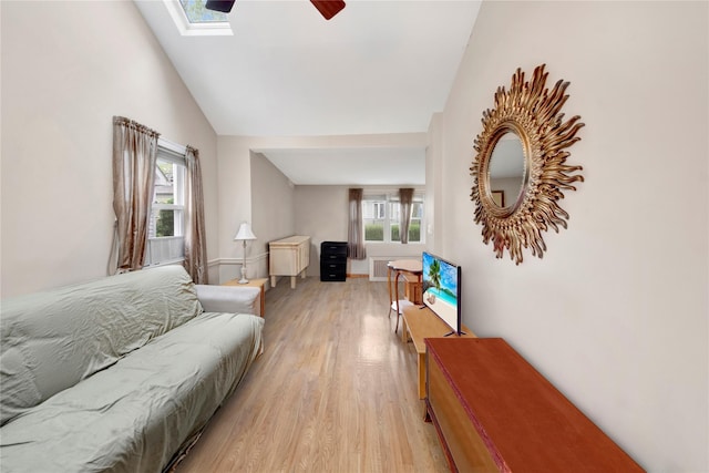 9 Magnolia Pl Unit 1, Bronx, NY 10465 - living room with light wood-style floors, ceiling fan, a skylight, high vaulted ceiling, and baseboards