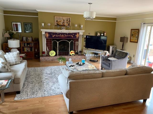 2975 Rte 9, Cold Spring, NY 10516 - living area featuring crown molding, a tiled fireplace, and wood finished floors
