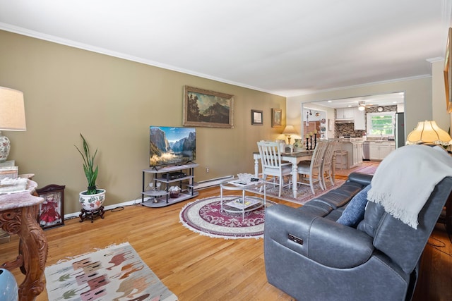 2975 Rte 9, Cold Spring, NY 10516 - living room featuring light wood-type flooring, ornamental molding, baseboards, a baseboard heating unit, and a ceiling fan