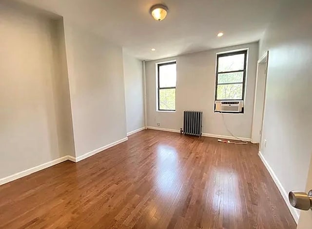5840 Catalpa Ave, Ridgewood, NY 11385 - unfurnished room with radiator heating unit, dark wood-type flooring, baseboards, recessed lighting, and cooling unit