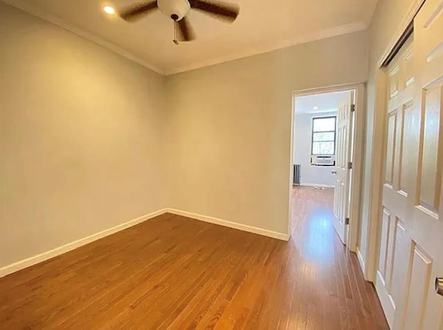 5840 Catalpa Ave, Ridgewood, NY 11385 - empty room with a ceiling fan, baseboards, dark wood-style flooring, and crown molding