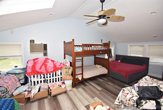 1330 William Floyd Pkwy, Shirley, NY 11967 - bedroom featuring vaulted ceiling, wood finished floors, a ceiling fan, a skylight, and a wall unit AC