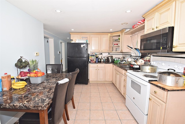 1330 William Floyd Pkwy, Shirley, NY 11967 - kitchen with white electric stove, freestanding refrigerator, stainless steel microwave, cream cabinets, and light tile patterned floors