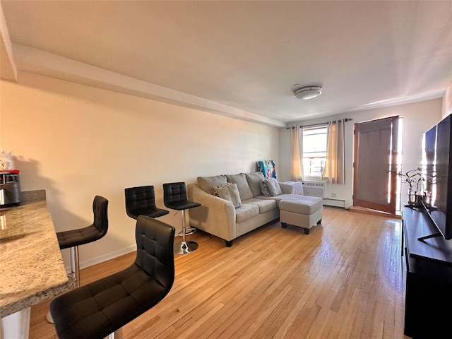 35-38 Junction Blvd Unit 6C, Jackson Heights, NY 11368 - living room featuring light wood-type flooring, baseboards, and a baseboard heating unit