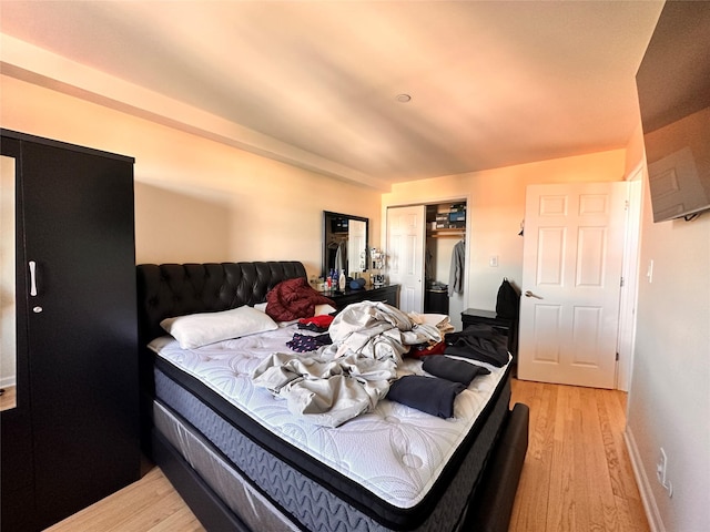 35-38 Junction Blvd Unit 6C, Jackson Heights, NY 11368 - bedroom featuring light wood-style flooring, a closet, freestanding refrigerator, and baseboards