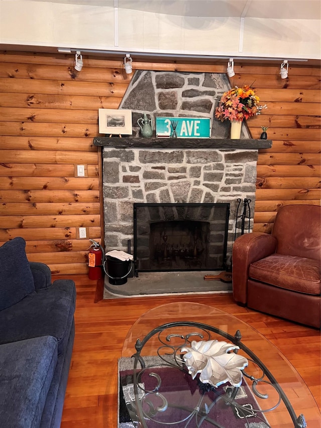23 N Seminole Trl, Bethel, NY 12778 - living area with rustic walls, wood finished floors, and a stone fireplace