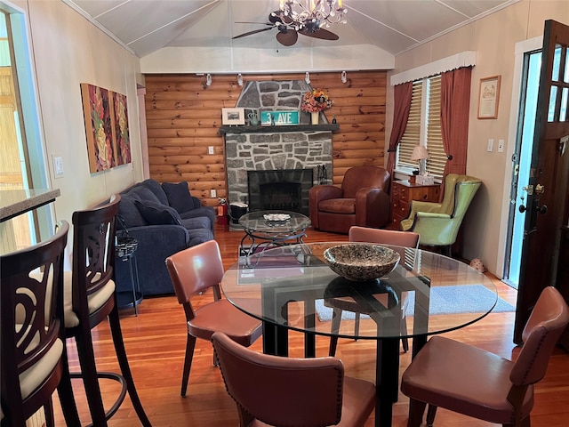 23 N Seminole Trl, Bethel, NY 12778 - dining area featuring log walls, light wood-type flooring, lofted ceiling, a stone fireplace, and a ceiling fan