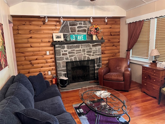 23 N Seminole Trl, Bethel, NY 12778 - living area featuring rustic walls, wood finished floors, vaulted ceiling, and a stone fireplace