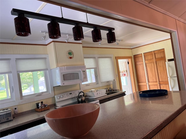 23 N Seminole Trl, Bethel, NY 12778 - kitchen with white appliances, crown molding, light stone counters, and brown cabinetry