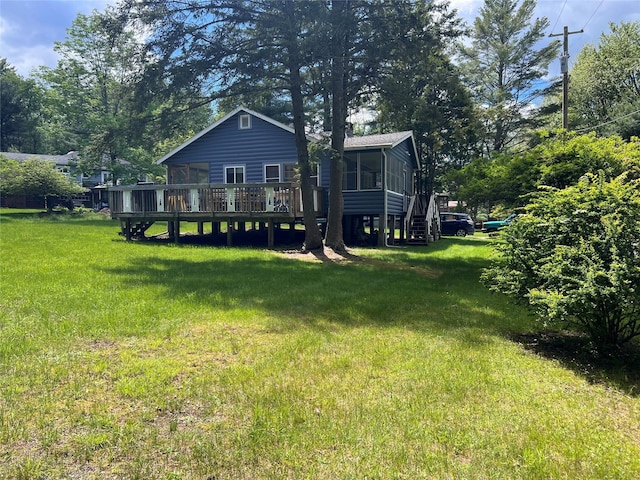 23 N Seminole Trl, Bethel, NY 12778 - back of house featuring a sunroom, a wooden deck, and a lawn