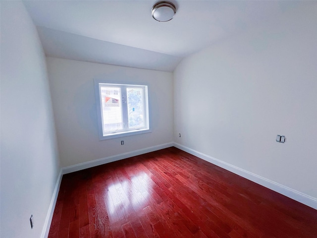 208-04 47th Ave, Bayside, NY 11361 - unfurnished room with wood finished floors, baseboards, and vaulted ceiling
