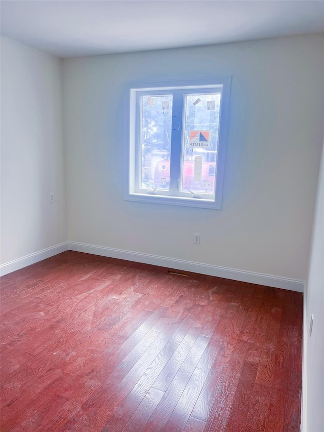 208-04 47th Ave, Bayside, NY 11361 - empty room with wood finished floors and baseboards