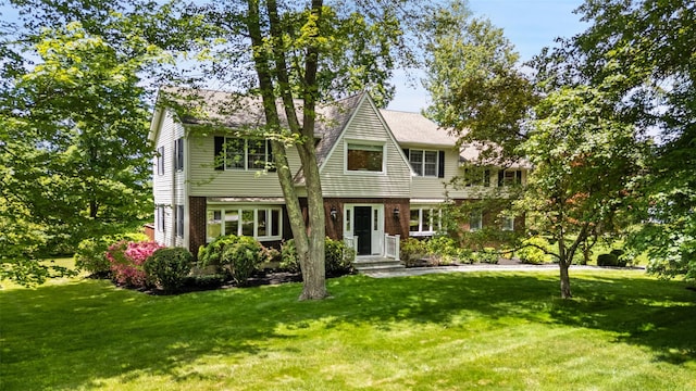 2 Shoshone Dr, Katonah, NY 10536 - shingle-style home featuring a front lawn and brick siding