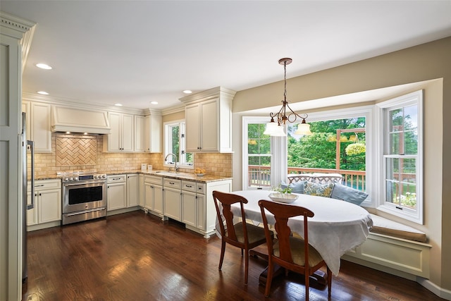 2 Shoshone Dr, Katonah, NY 10536 - kitchen with stainless steel range, breakfast area, a sink, light stone countertops, and decorative backsplash